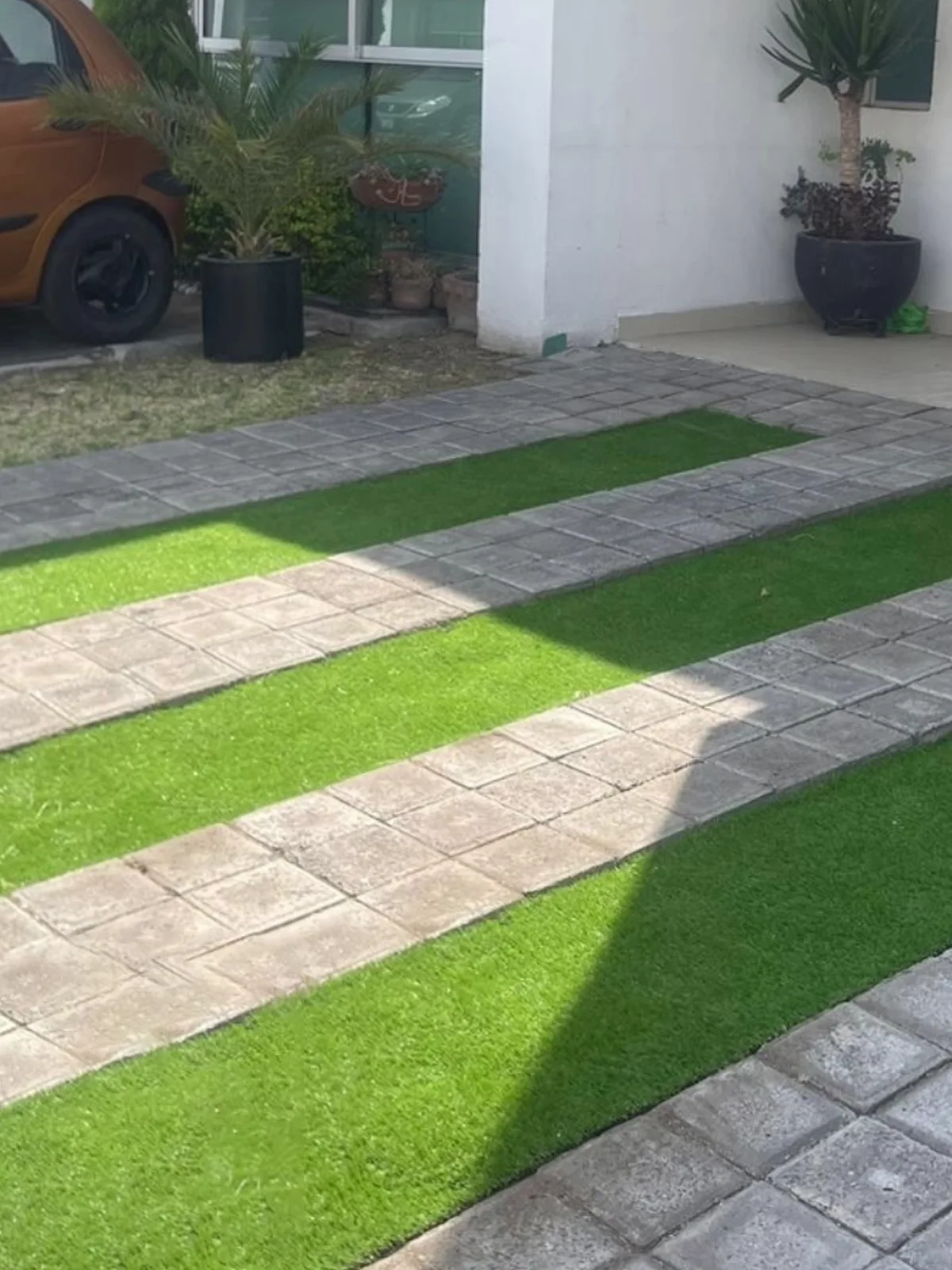 Jardín con pasto sintético resistente y de bajo mantenimiento